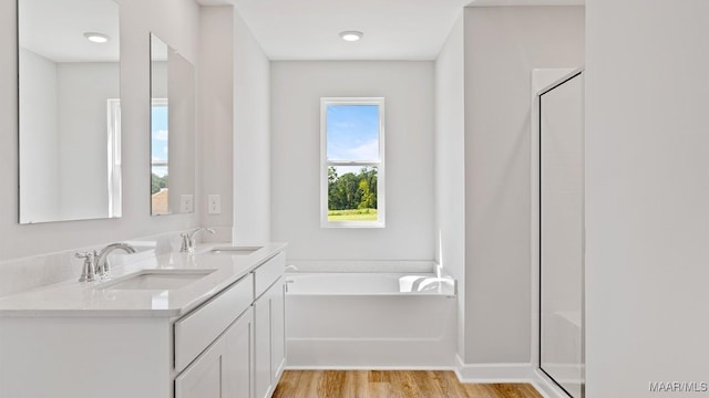 6008 Cunningham Trl, Montgomery, AL 36116 - full bathroom with a bath, wood finished floors, double vanity, and an enclosed shower