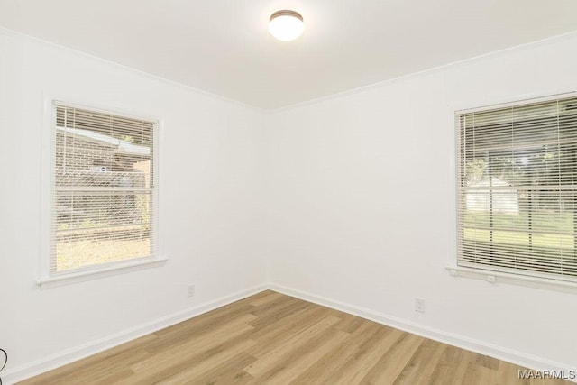 3119 Gaston Ave, Montgomery, AL 36105 - spare room featuring ornamental molding, light wood-type flooring, baseboards, and healthy amount of natural light