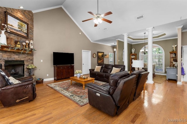 512 Golson Rd, Prattville, AL 36067 - living room with ornate columns, light wood-style floors, a ceiling fan, a stone fireplace, and high vaulted ceiling