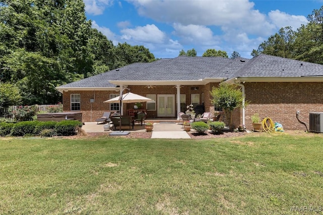 512 Golson Rd, Prattville, AL 36067 - back of property featuring french doors, brick siding, a patio, a hot tub, and a yard