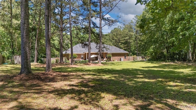 512 Golson Rd, Prattville, AL 36067 - view of green lawn with a wooded view
