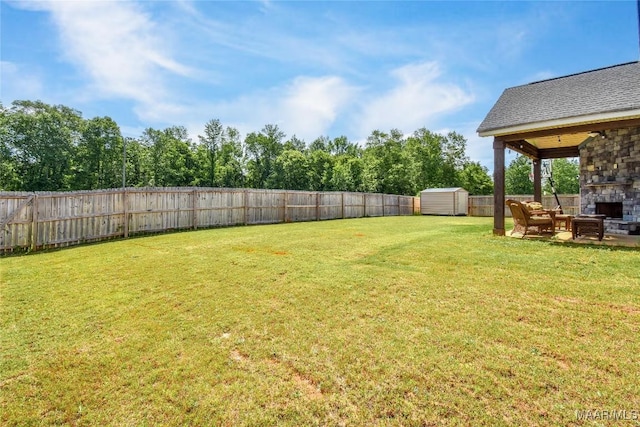 688 Tiger Trl, Opelika, AL 36804 - view of yard featuring an outdoor stone fireplace and a patio area