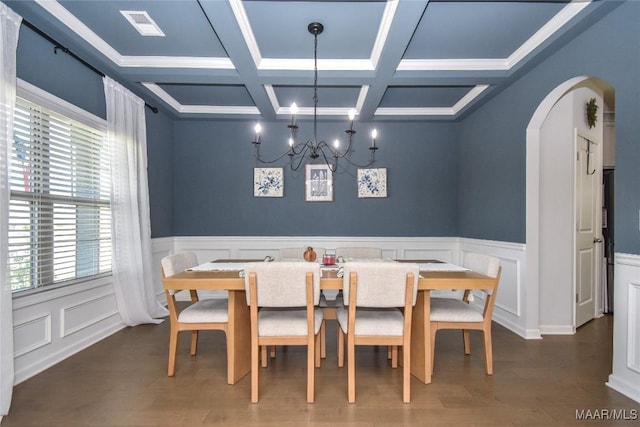 688 Tiger Trl, Opelika, AL 36804 - dining area featuring plenty of natural light, arched walkways, a chandelier, coffered ceiling, and wood finished floors