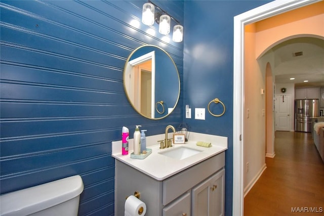 688 Tiger Trl, Opelika, AL 36804 - half bath featuring toilet, vanity, baseboards, and wood finished floors