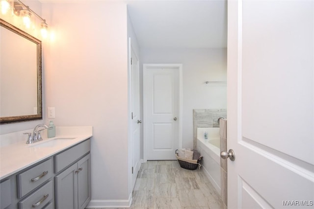 688 Tiger Trl, Opelika, AL 36804 - bathroom featuring vanity, a garden tub, and baseboards