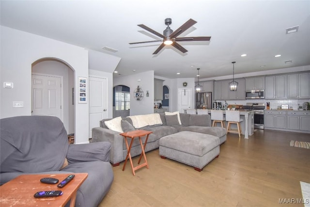 688 Tiger Trl, Opelika, AL 36804 - living area featuring arched walkways, ceiling fan, light wood-type flooring, and recessed lighting