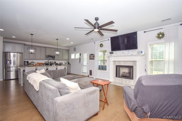 688 Tiger Trl, Opelika, AL 36804 - living area with plenty of natural light, a ceiling fan, light wood-type flooring, recessed lighting, and a tile fireplace