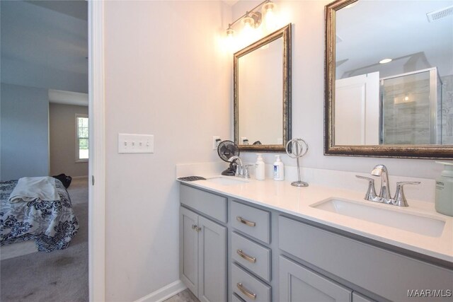 688 Tiger Trl, Opelika, AL 36804 - ensuite bathroom with double vanity, a shower stall, and baseboards