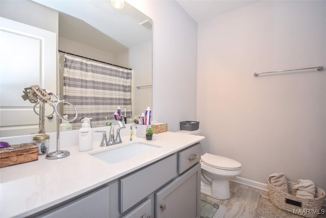 688 Tiger Trl, Opelika, AL 36804 - full bath with toilet, vanity, baseboards, and wood finished floors