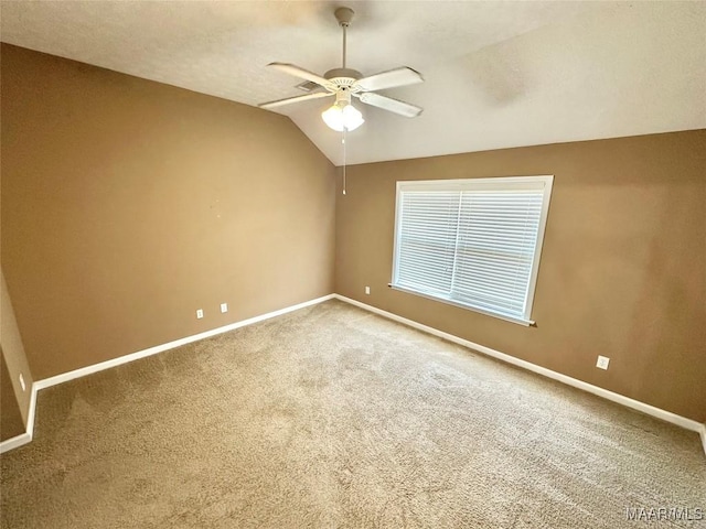 10617 Harcourt Trce, Montgomery, AL 36117 - empty room featuring ceiling fan, carpet, baseboards, and vaulted ceiling