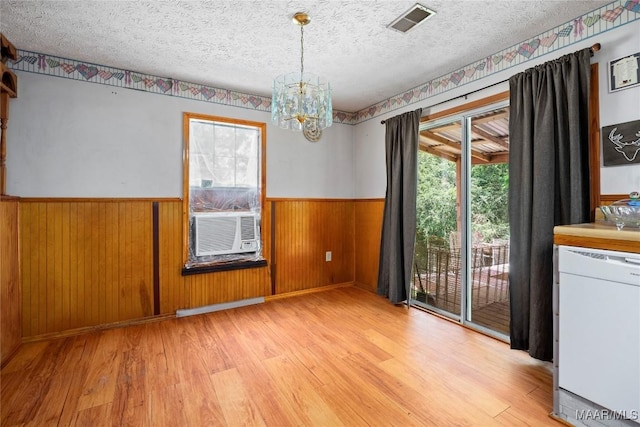 6390 County Road 37, Valley Grande, AL 36701 - unfurnished dining area featuring light wood-style floors, plenty of natural light, wainscoting, a chandelier, and a textured ceiling