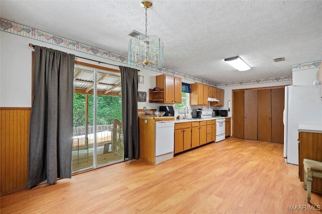 6390 County Road 37, Valley Grande, AL 36701 - kitchen with white appliances, light countertops, light wood-style flooring, a textured ceiling, and a chandelier