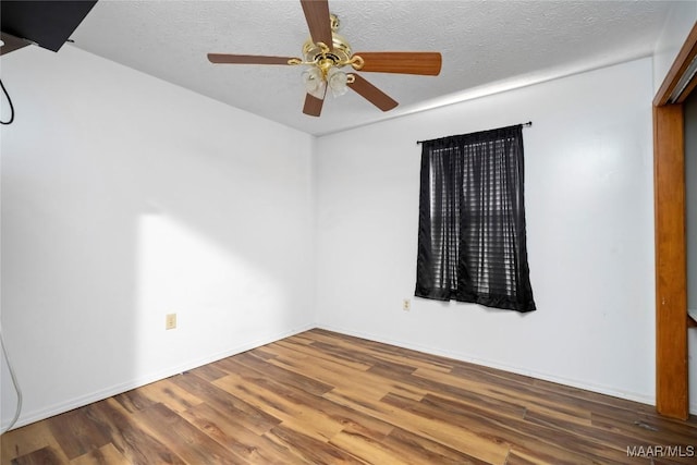 6390 County Road 37, Valley Grande, AL 36701 - unfurnished room featuring wood finished floors, a ceiling fan, a textured ceiling, and baseboards