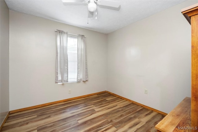 6390 County Road 37, Valley Grande, AL 36701 - empty room with wood finished floors, baseboards, and a ceiling fan