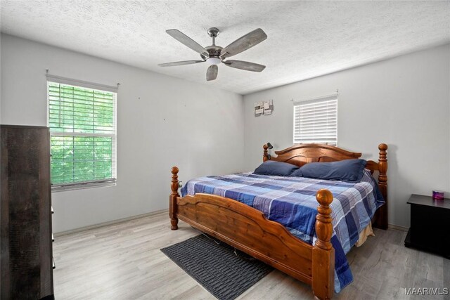 6390 County Road 37, Valley Grande, AL 36701 - bedroom featuring wood finished floors, a textured ceiling, and ceiling fan