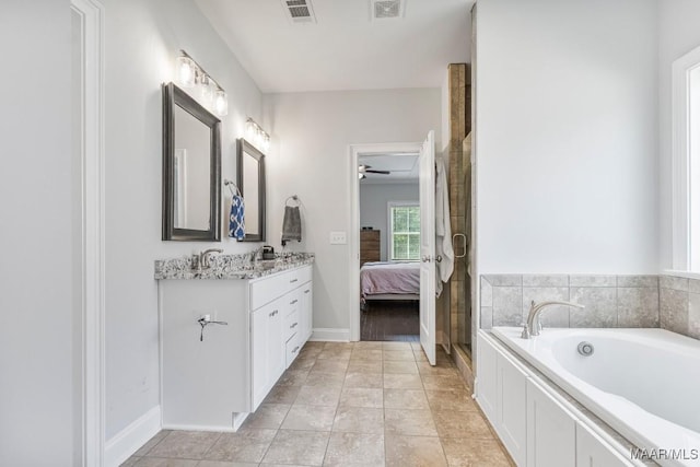 1478 Trolley Rd, Prattville, AL 36066 - bathroom with double vanity, a garden tub, a ceiling fan, a shower with shower door, and baseboards