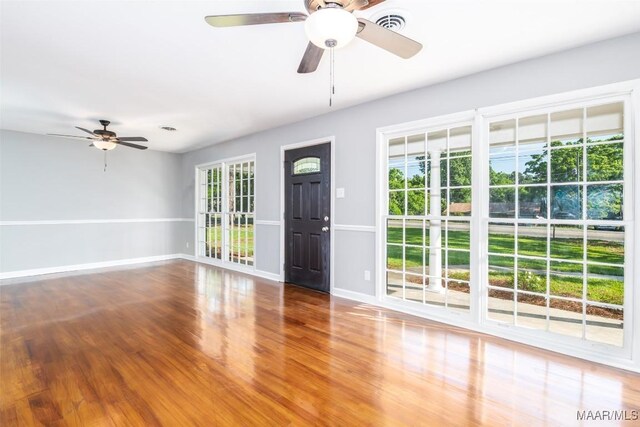 3212 Mcgehee Rd, Montgomery, AL 36111 - unfurnished living room with a ceiling fan, wood finished floors, and baseboards