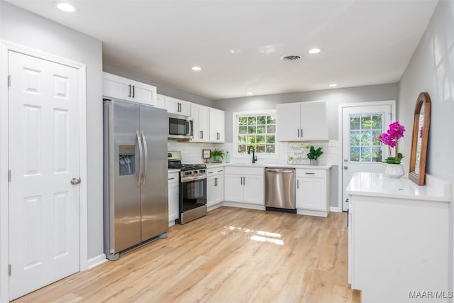3212 Mcgehee Rd, Montgomery, AL 36111 - kitchen with appliances with stainless steel finishes, light wood-type flooring, backsplash, and recessed lighting