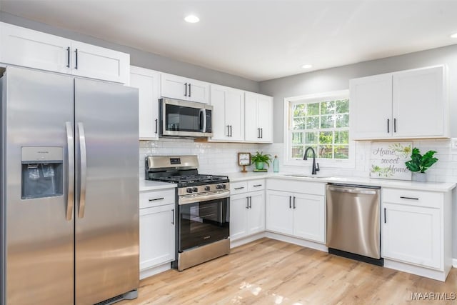 3212 Mcgehee Rd, Montgomery, AL 36111 - kitchen featuring stainless steel appliances, a sink, light countertops, white cabinetry, and recessed lighting