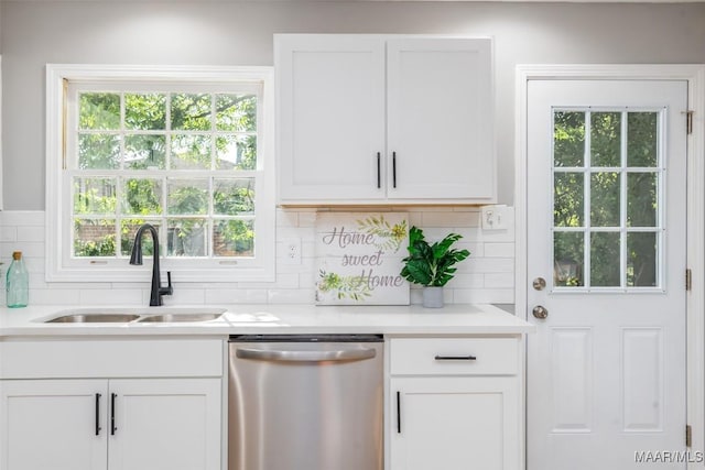 3212 Mcgehee Rd, Montgomery, AL 36111 - kitchen featuring dishwasher, a sink, light countertops, backsplash, and white cabinets