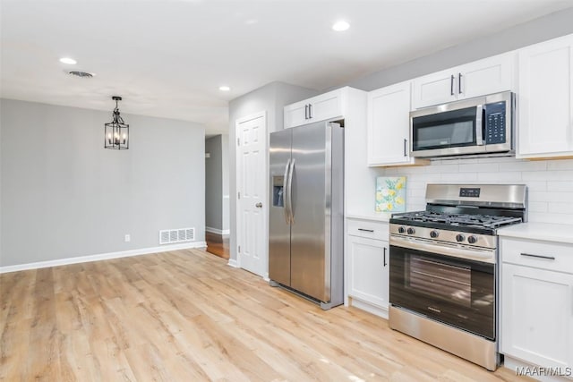 3212 Mcgehee Rd, Montgomery, AL 36111 - kitchen with appliances with stainless steel finishes, light wood-style flooring, white cabinets, baseboards, and recessed lighting