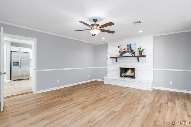 3212 Mcgehee Rd, Montgomery, AL 36111 - unfurnished living room featuring ceiling fan, light wood-style flooring, a brick fireplace, crown molding, and baseboards