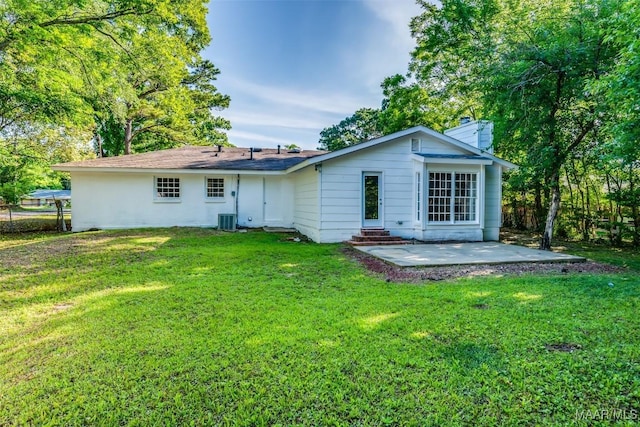 3212 Mcgehee Rd, Montgomery, AL 36111 - rear view of house featuring entry steps, a chimney, central AC unit, a patio, and a yard