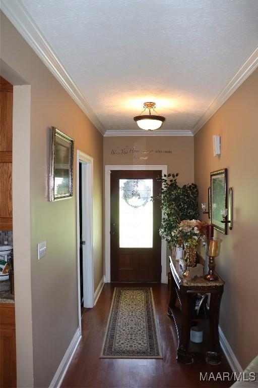 663 Hobbie Rd, Montgomery, AL 36105 - doorway to outside with wood finished floors, ornamental molding, and baseboards