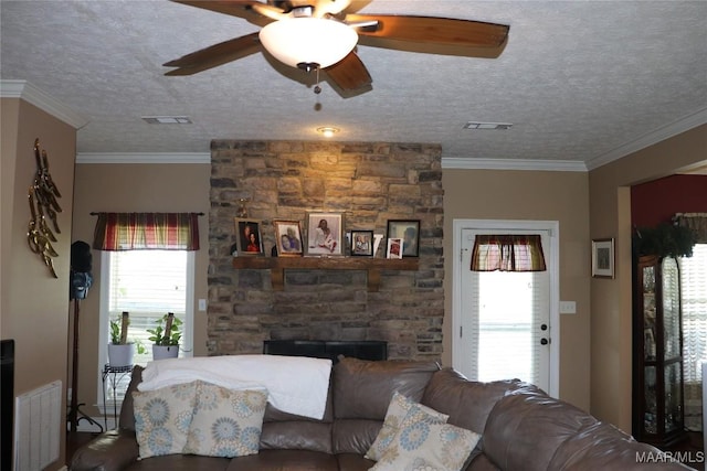 663 Hobbie Rd, Montgomery, AL 36105 - living area featuring ceiling fan, a textured ceiling, and a stone fireplace