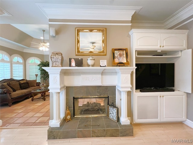 7178 Wyngrove Dr, Montgomery, AL 36117 - living area featuring crown molding, a tiled fireplace, ceiling fan, and light wood finished floors