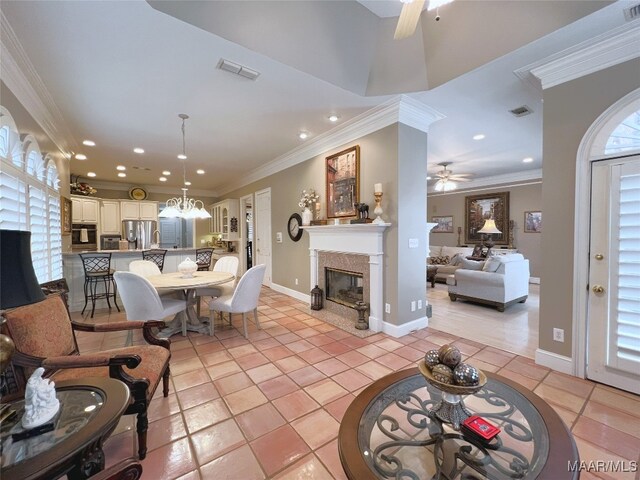 7178 Wyngrove Dr, Montgomery, AL 36117 - living area featuring a ceiling fan, a glass covered fireplace, light tile patterned floors, recessed lighting, and crown molding