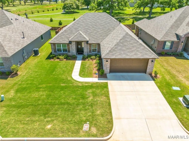 400 Lismore Pl, Montgomery, AL 36117 - view of front of property with brick siding, an attached garage, driveway, a shingled roof, and a front yard