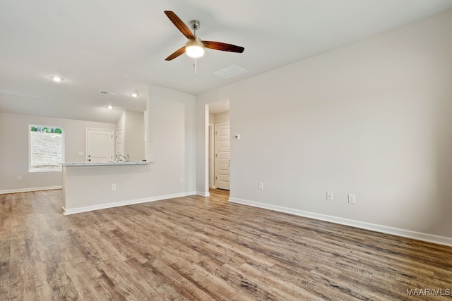 177 Canal Xing, Wetumpka, AL 36092 - unfurnished living room with wood finished floors, a ceiling fan, baseboards, and recessed lighting