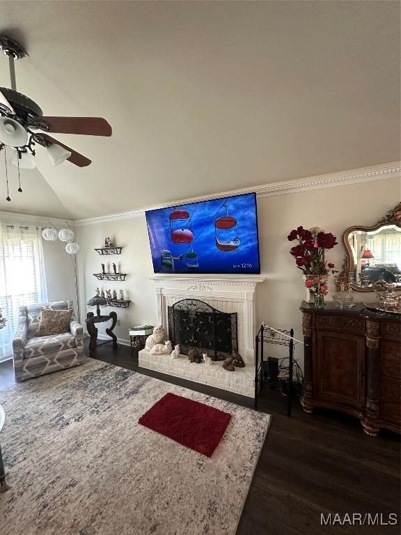 3932 Oak Ave, Montgomery, AL 36109 - living area featuring dark wood-style flooring, ceiling fan, crown molding, a brick fireplace, and vaulted ceiling