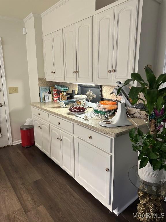 3932 Oak Ave, Montgomery, AL 36109 - kitchen with ornamental molding, white cabinets, dark wood-style floors, and backsplash