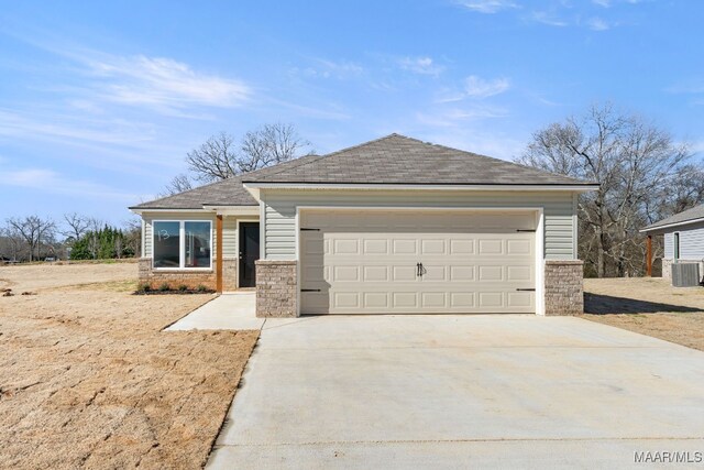 213 Canal Xing, Wetumpka, AL 36092 - view of front facade with concrete driveway, roof with shingles, stone siding, and an attached garage