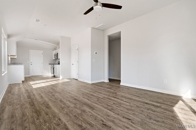 213 Canal Xing, Wetumpka, AL 36092 - unfurnished living room with ceiling fan, vaulted ceiling, wood finished floors, and baseboards