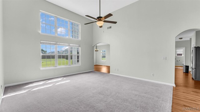 8 Honor Dr, Fort Mitchell, AL 36856 - carpeted spare room with arched walkways, ceiling fan, a towering ceiling, and baseboards