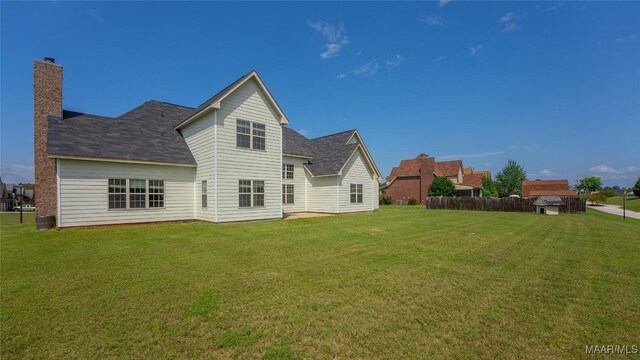 8 Honor Dr, Fort Mitchell, AL 36856 - back of house with a shingled roof and a chimney