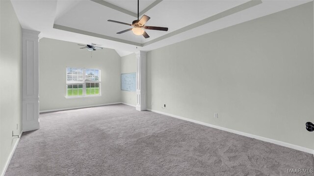 8 Honor Dr, Fort Mitchell, AL 36856 - carpeted empty room with a raised ceiling, a ceiling fan, baseboards, and decorative columns