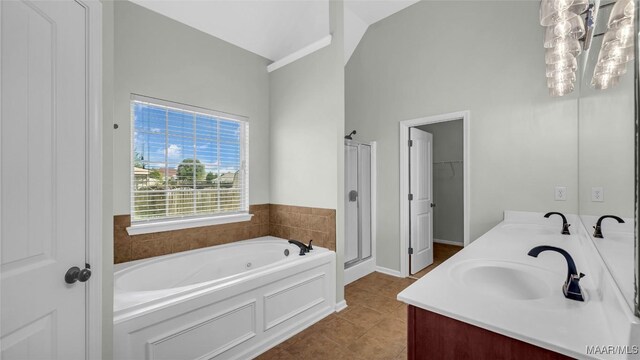 8 Honor Dr, Fort Mitchell, AL 36856 - bathroom featuring a jetted tub, double vanity, a shower stall, tile patterned floors, and high vaulted ceiling