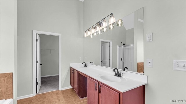 8 Honor Dr, Fort Mitchell, AL 36856 - full bath featuring double vanity, tile patterned flooring, a walk in closet, baseboards, and a shower