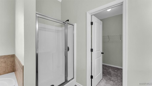 8 Honor Dr, Fort Mitchell, AL 36856 - bathroom featuring a shower stall, a walk in closet, and a garden tub