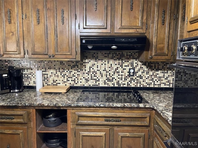 1003 Keith Way, Selma, AL 36701 - kitchen with exhaust hood, black appliances, backsplash, and dark stone counters