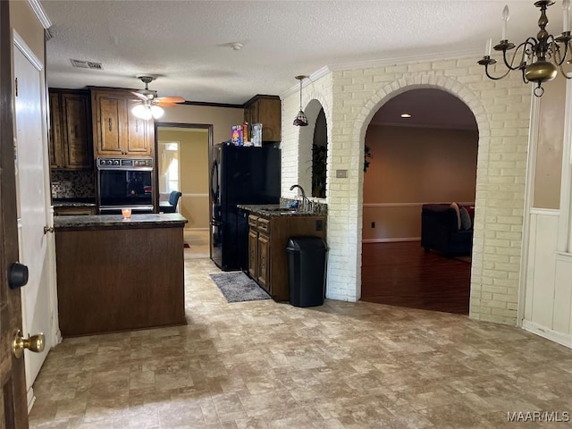 1003 Keith Way, Selma, AL 36701 - kitchen featuring black appliances, a sink, ceiling fan, a textured ceiling, and arched walkways