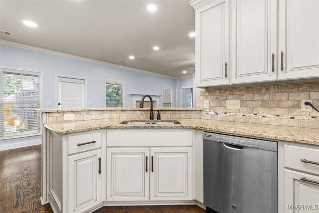 9148 Autumnbrooke Way, Montgomery, AL 36117 - kitchen with stainless steel dishwasher, a sink, ornamental molding, plenty of natural light, and white cabinets