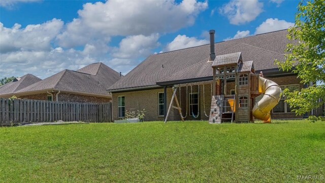 9148 Autumnbrooke Way, Montgomery, AL 36117 - rear view of house with a playground, brick siding, and roof with shingles
