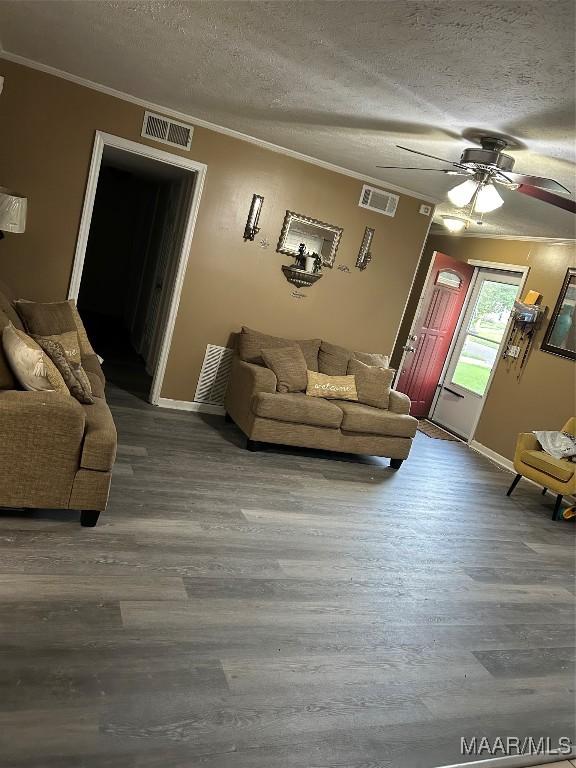 2276 E Aberdeen Dr, Montgomery, AL 36116 - living room with crown molding, wood finished floors, a textured ceiling, ceiling fan, and baseboards
