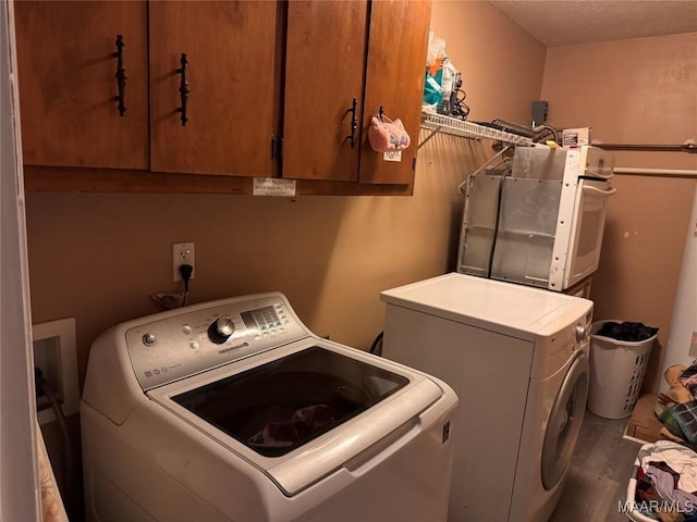 2276 E Aberdeen Dr, Montgomery, AL 36116 - washroom with washing machine and dryer, cabinet space, and wood finished floors