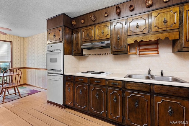 5241 County Road 48th Rd, Jemison, AL 35085 - kitchen featuring white appliances, wallpapered walls, a sink, a textured ceiling, and under cabinet range hood